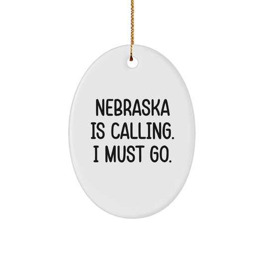 Funny Nebraska Oval Ornament, Gifts from Men to Family for Christmas Season, 'Nebraska Is Calling. I Must Go.' Quote Decorations, Oval Shaped, White Color, Ideal Gifts for Nebraska Lovers - Image 1